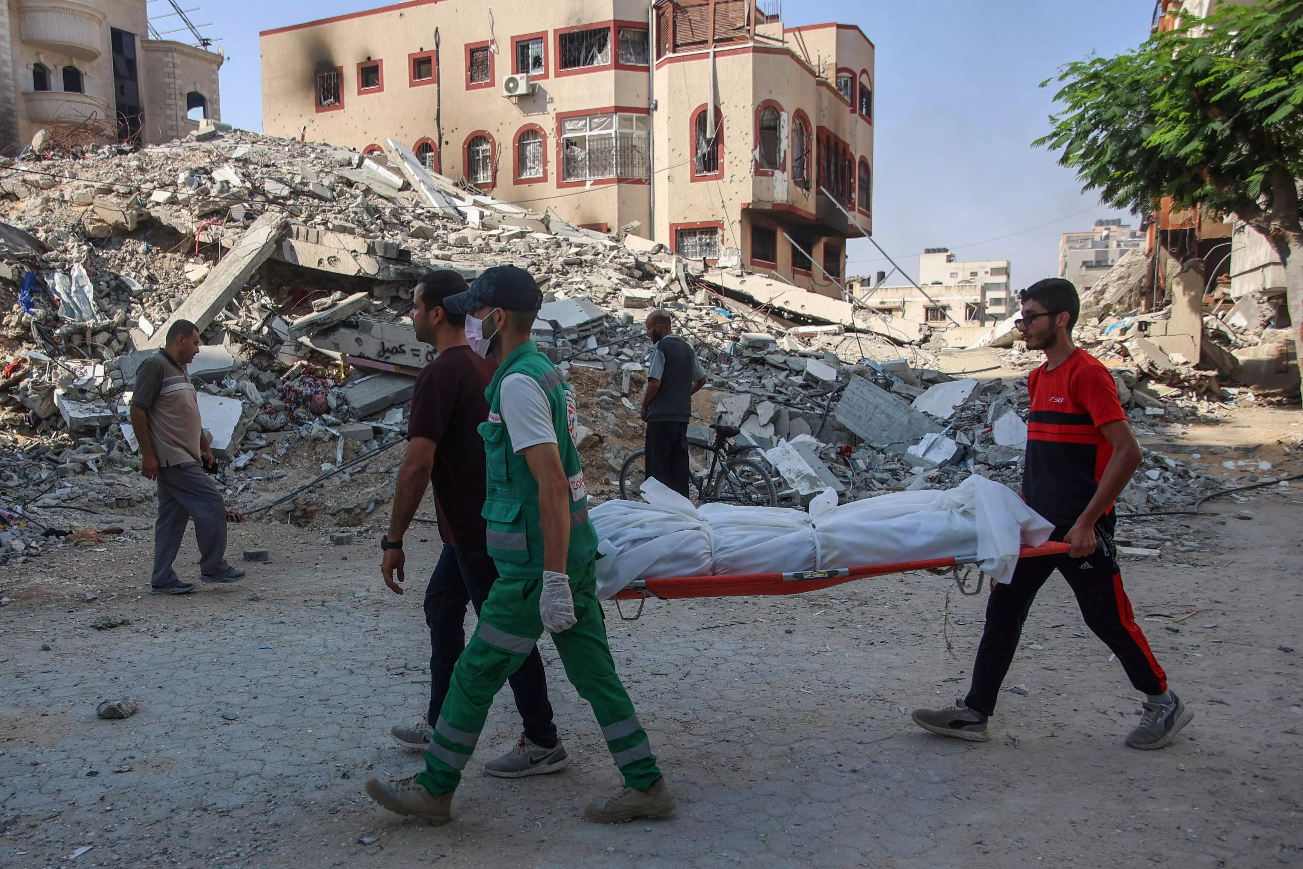 Emergency workers uncover dozens of bodies in a Gaza City district after Israeli assault