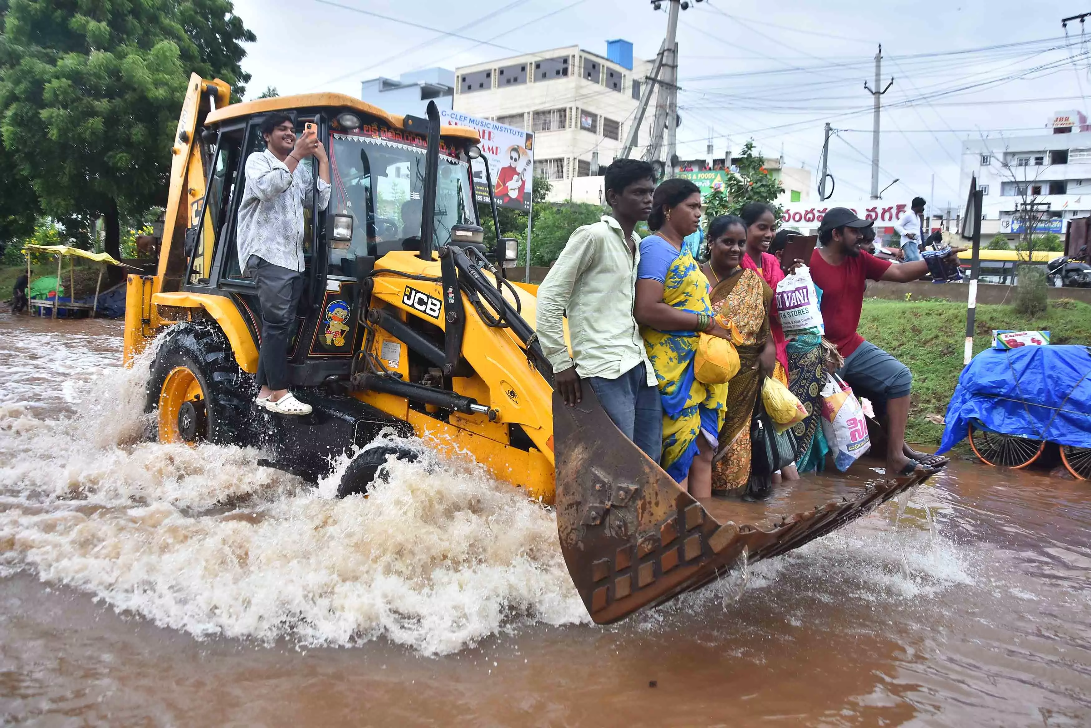 Residents take refuge on roofs as Budameru canal floods