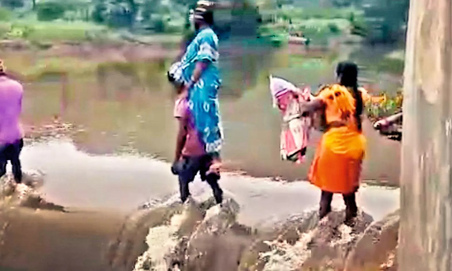 AP: Tribals brave swollen stream to carry mother, newborn across