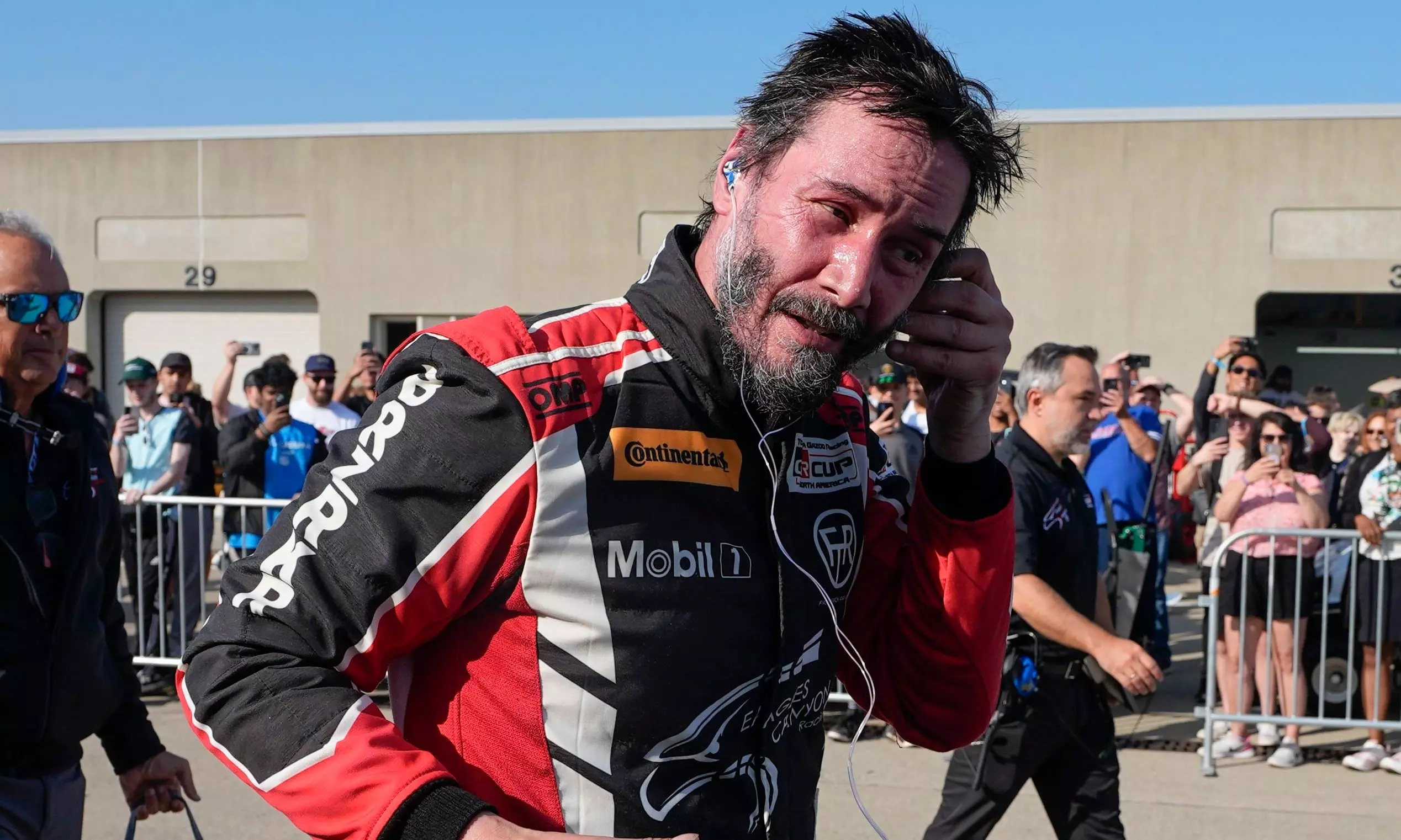 Keanu Reeves escapes injury during pro auto racing debut