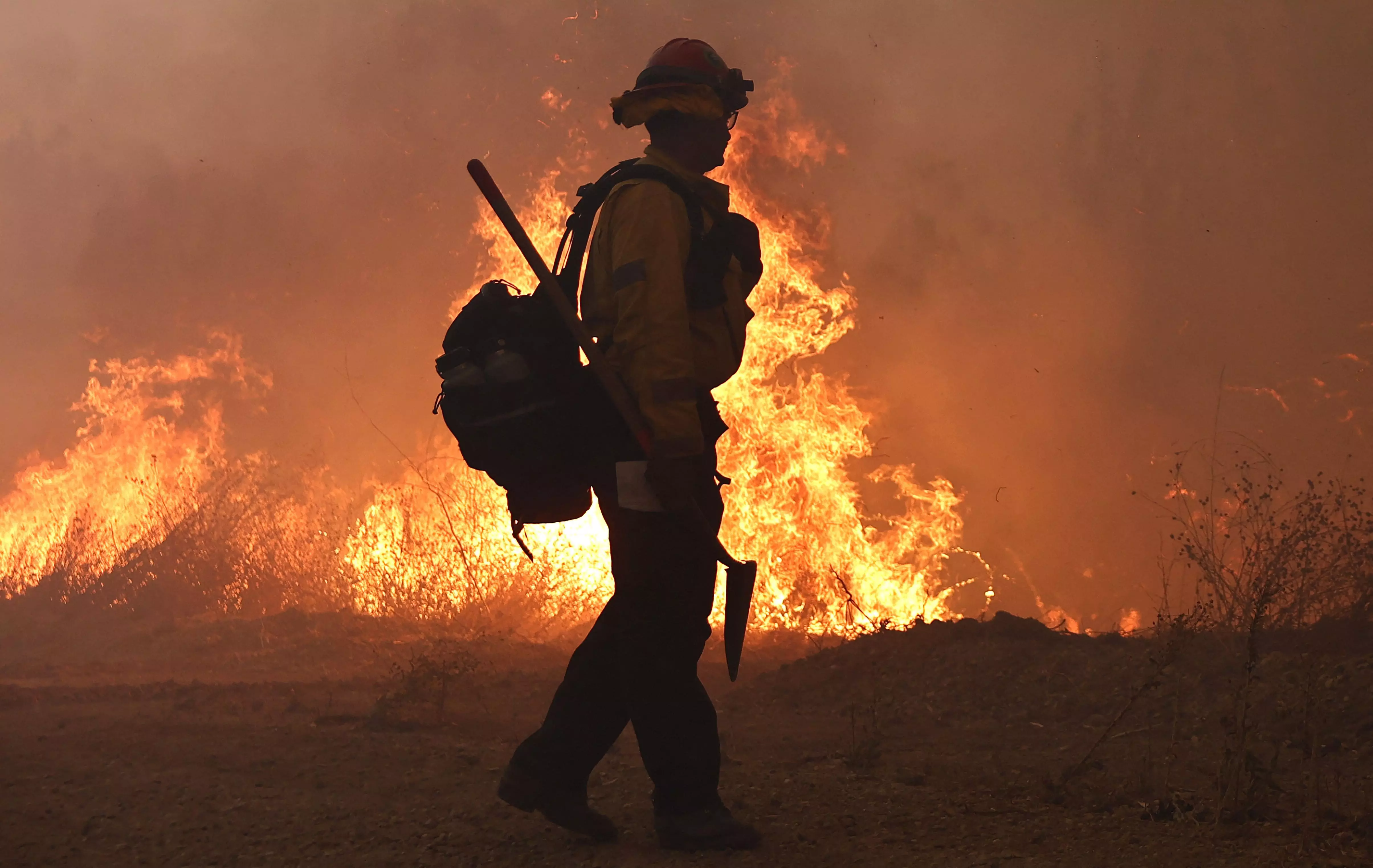 California wildfire burns out of control but firefighters could get a break when winds diminish