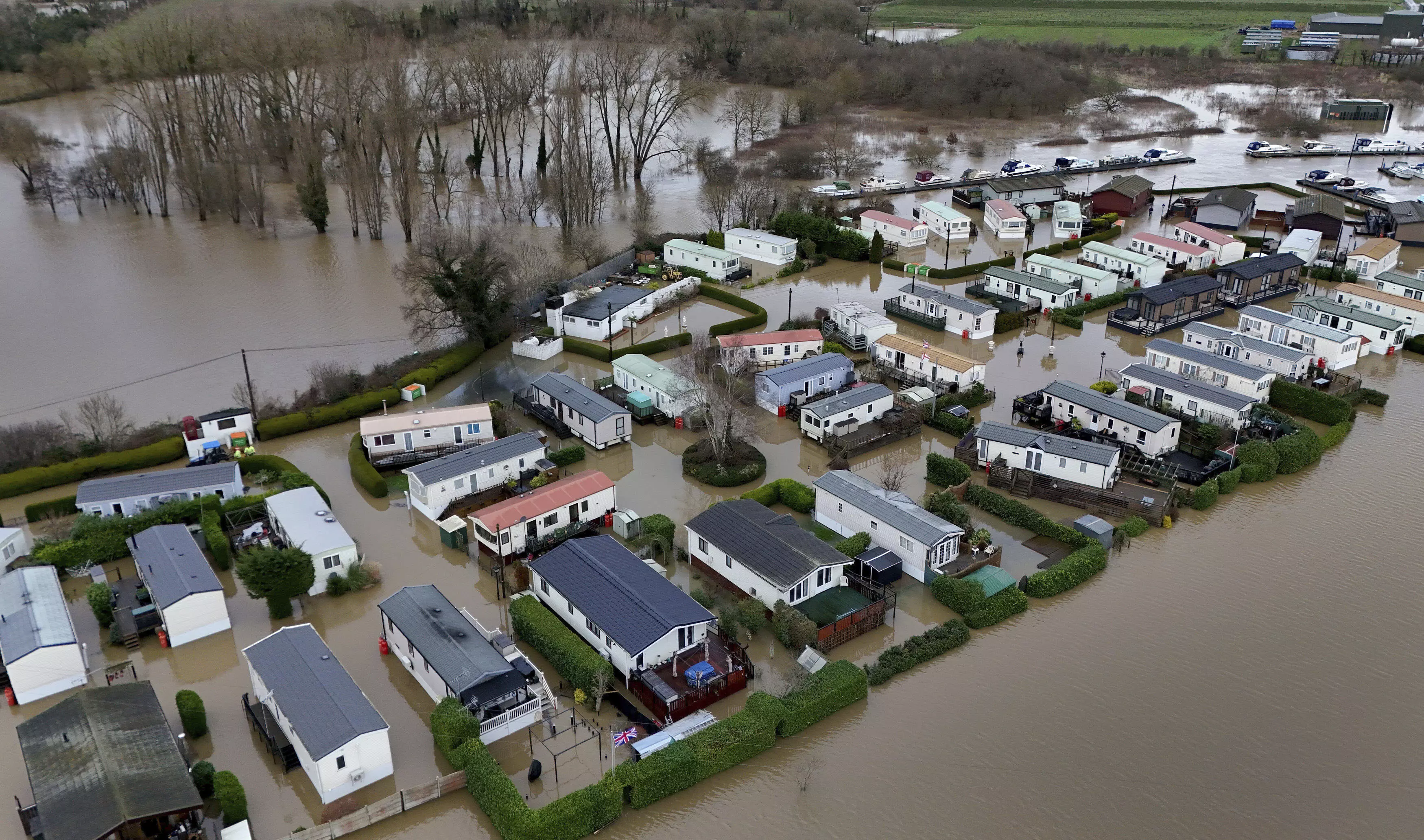 Rain and snow lead to flooding and disrupt travel in parts of the UK